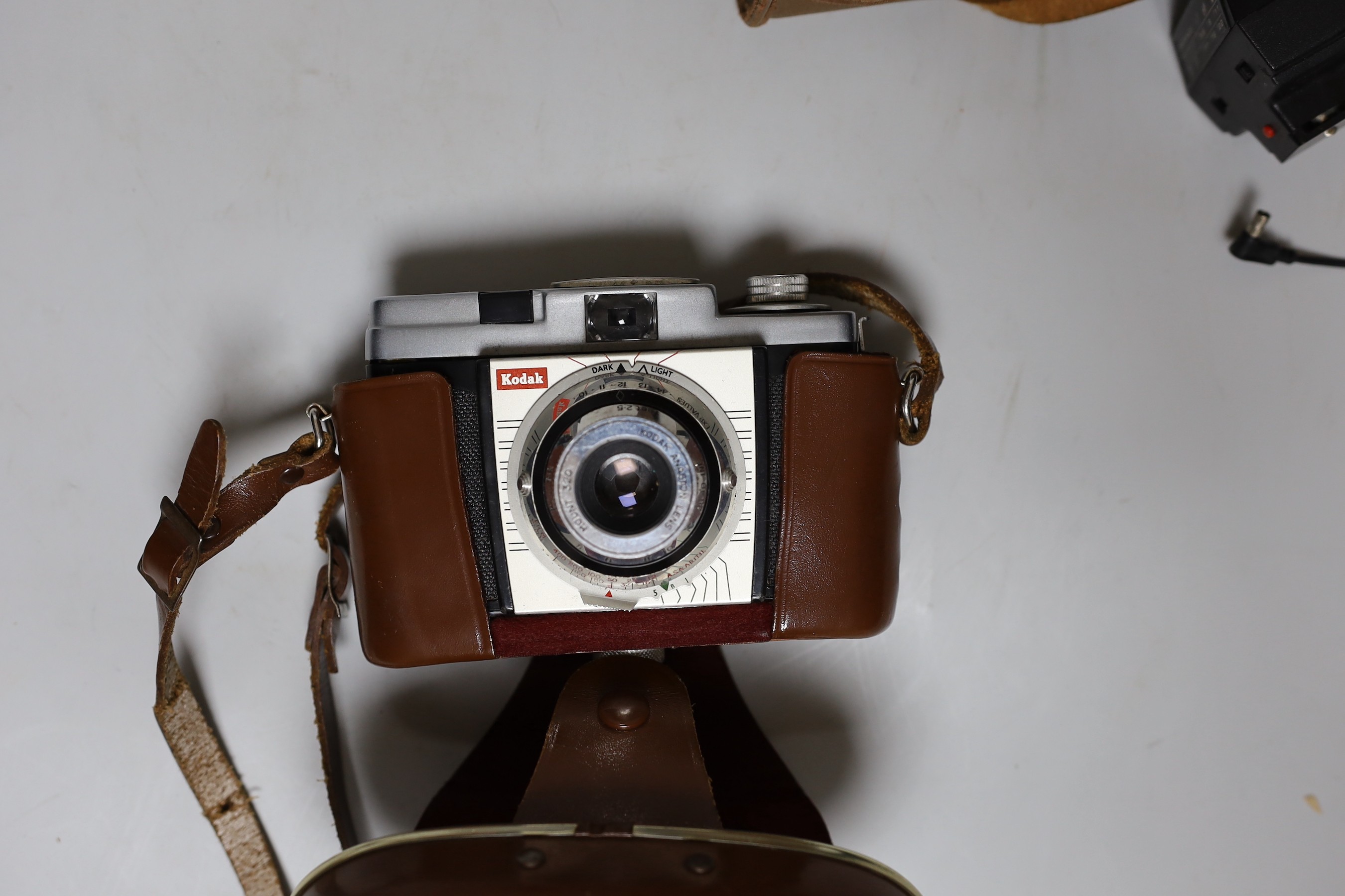 Three cameras, two cased plus a flash and light meter